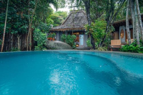 a swimming pool in front of a house at View Point Resort in Koh Tao