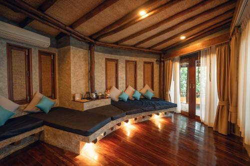a living room with two beds in a room with wooden floors at View Point Resort in Koh Tao