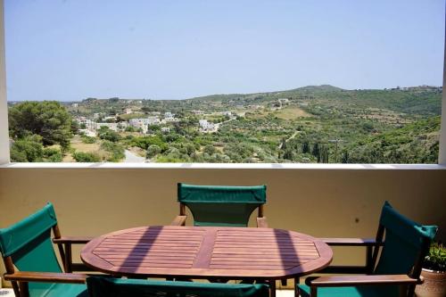 a table and chairs on a balcony with a view at The Baker's Loft in Kýthira