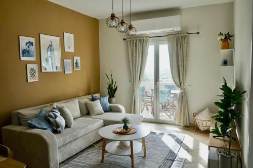 a living room with a couch and a table at The Baker's Loft in Kýthira