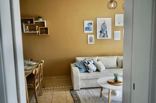 a living room with a couch and a table at The Baker's Loft in Kýthira