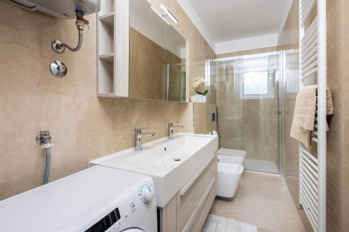 ein Badezimmer mit einem weißen Waschbecken und einer Toilette in der Unterkunft Tonka Roberta 2 in Crikvenica