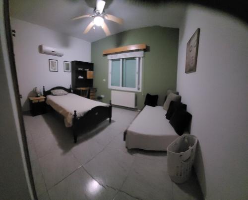 a living room with two beds and a couch at Beautiful bedroom in Limassol