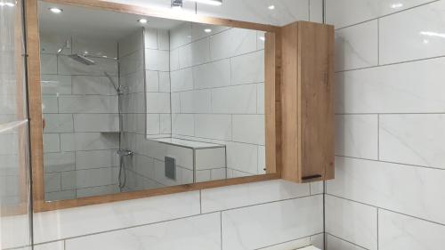 a bathroom with a shower and a mirror at 18 on the Rue in Eymet