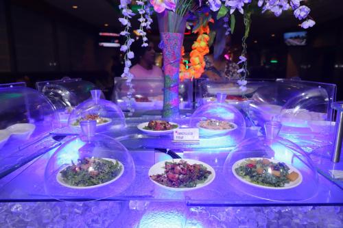 a buffet with plates of food on a purple table at SkyCity Hotel Gurgaon in Gurgaon