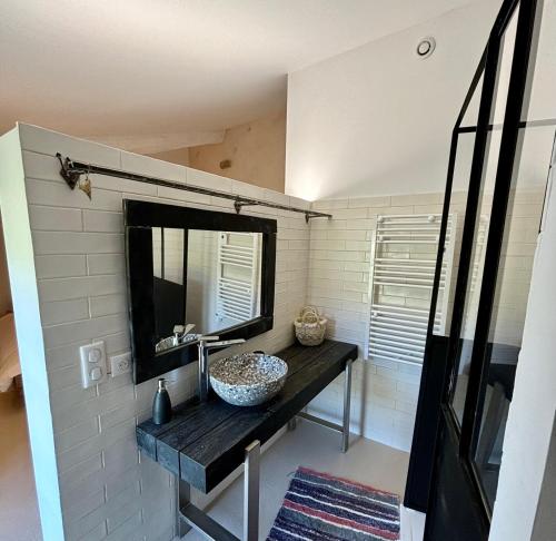a bathroom with a sink and a mirror at L Ostau de la Treille in Limans