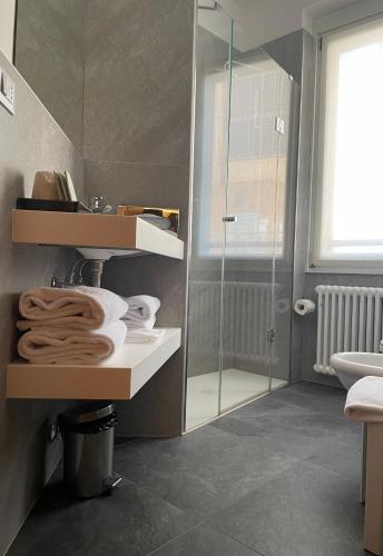 a bathroom with a sink and a glass shower at Là Di Moret in Udine