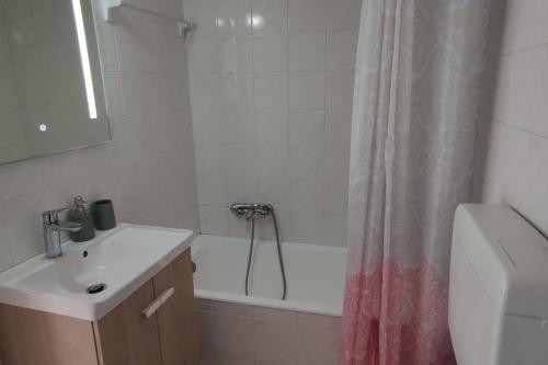 a bathroom with a sink and a shower curtain at Central Loft 7 in Kalamata