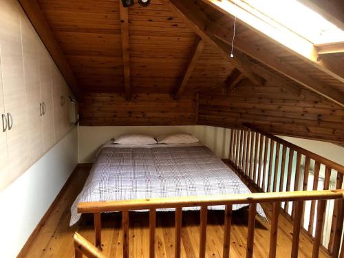 a bedroom with a bed in a wooden attic at Central Loft 7 in Kalamata