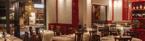 a restaurant with tables and chairs in a room at Affittacamere Limin in Busto Arsizio