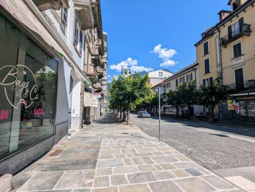 an empty street in a city with buildings at Domus Aurea in Domodossola