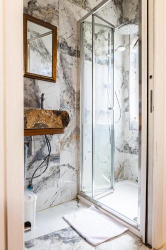 a bathroom with a shower and a sink at Historic Hideaways - 900 Year Old Converted Studios in Victoria