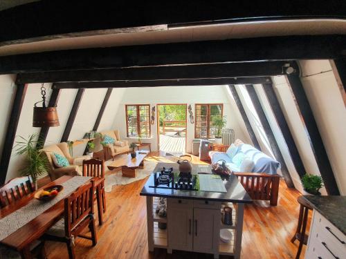 an open living room with a table and chairs at Hide Away Cabin in Knysna