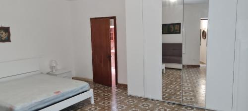 a bedroom with a bed and a mirror at Nonno Ludovico in Roccasicura