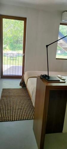 a bedroom with a bed and a desk with a lamp at Numa Experimental in Pontevedra