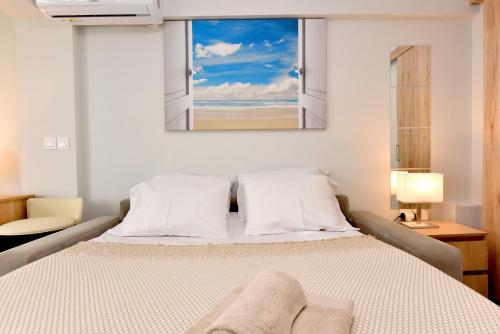 a bedroom with a large bed with a window at AMELIA apartment in Nea Moudania