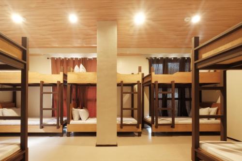 a group of bunk beds in a room at GHIELLANIQA INN in San Nicolas