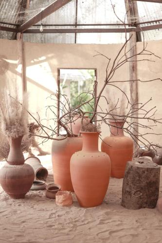 a group of clay vases sitting on the ground at Naturetalk Homestay in Ban Don