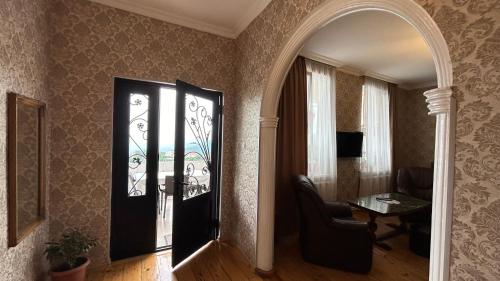 a hallway with a room with a chair and a table at Guest House Maria in Sighnaghi