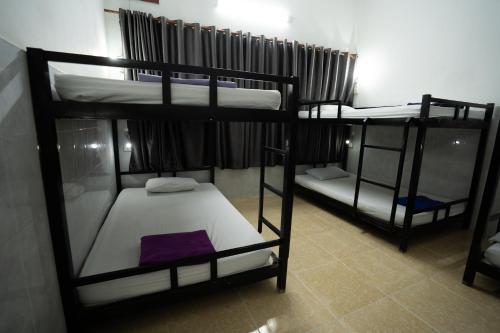 a room with three bunk beds in a room at The Eighty8 PP in Phnom Penh
