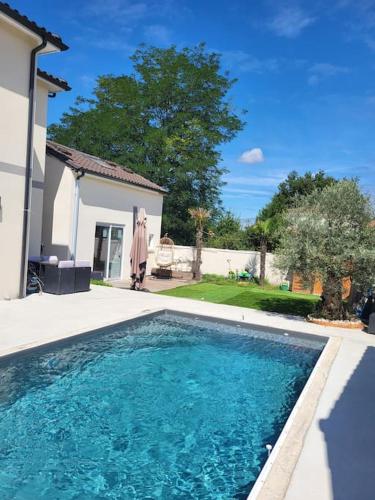 une piscine devant une maison dans l'établissement maison indépendante avec piscine, à Saint-Médard-en-Jalles