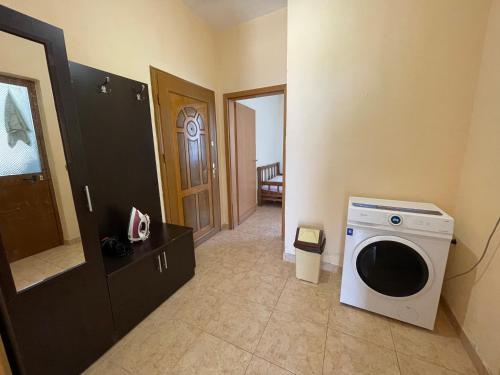 a living room with a washing machine in a room at House for rent Jurgen in Golem