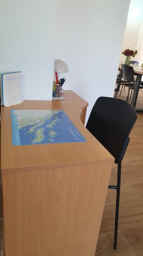 a desk with a book on it with a chair at Holiday house - Dvori Vlahovici in Opuzen