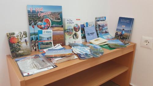 a table with books and signs on it at Holiday house - Dvori Vlahovici in Opuzen