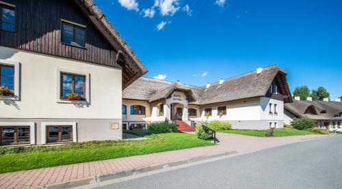 a large white house with a gambrel roof at Hotel SKANZEN in Velehrad