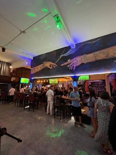 a group of people standing in a restaurant at The Eighty8 PP in Phnom Penh
