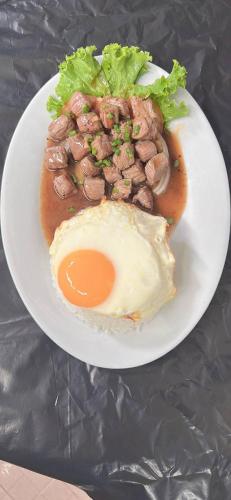 a plate of food with an egg and a salad at The Eighty8 PP in Phnom Penh