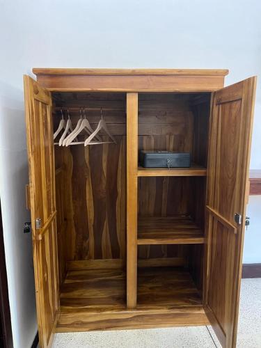 a wooden cabinet with white shoes in it at Villa Kamaria in Gili Air