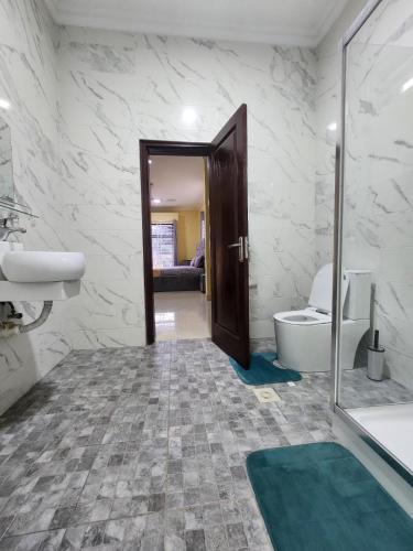a bathroom with a tub and a toilet and a sink at 2 bedroom Jab Villa in Adentan