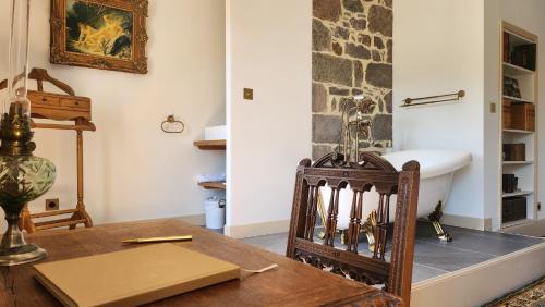 a dining room with a table and a sink at Château de Longevergne in Anglards-de-Salers