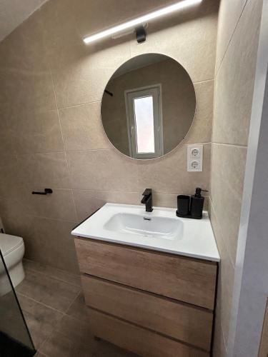 a bathroom with a sink and a mirror at La Floresta Suite in Sant Cugat del Vallès