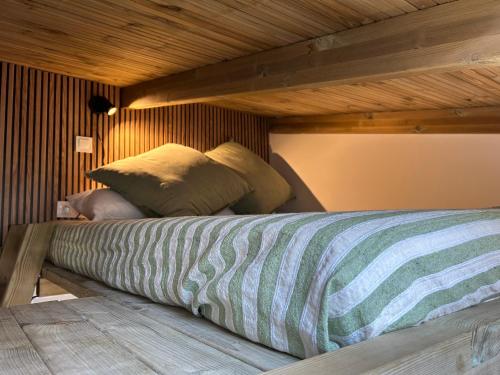 a bed in a room with a wooden ceiling at La Floresta Suite in Sant Cugat del Vallès
