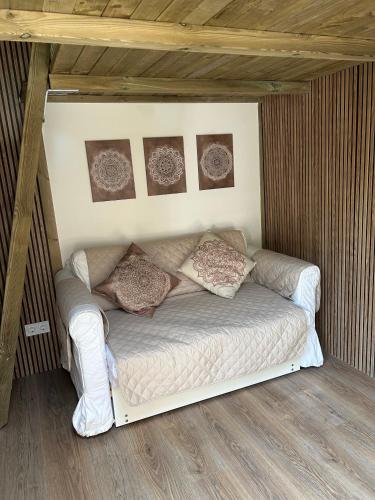 a bed in a room with pictures on the wall at La Floresta Suite in Sant Cugat del Vallès