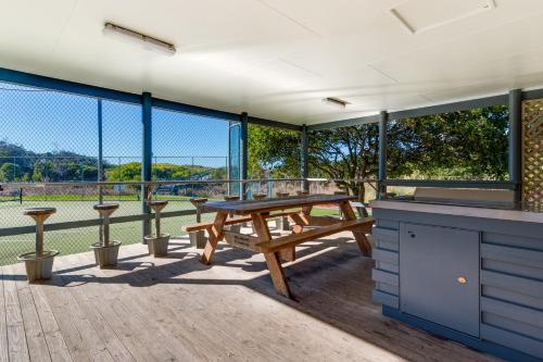 a picnic table on a deck with a view at Casa Tropicana Villa with Ocean Views - Steps from Beach Surfs Up! in Sapphire Beach