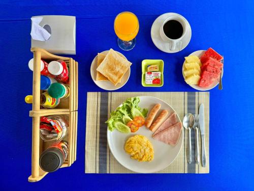 a table with a plate of breakfast food and a cup of coffee at Diamond de pai in Pai