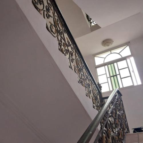 a staircase in a house with a window at Villa 91 in Salalah