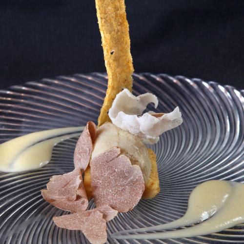 a piece of food sitting on a plate with a fork at Il Cascinalenuovo in Asti