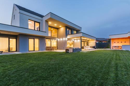 a rendering of a house with a large yard at HIRUNDO- villa with saunas and hot tub in Sela pri Dobovi