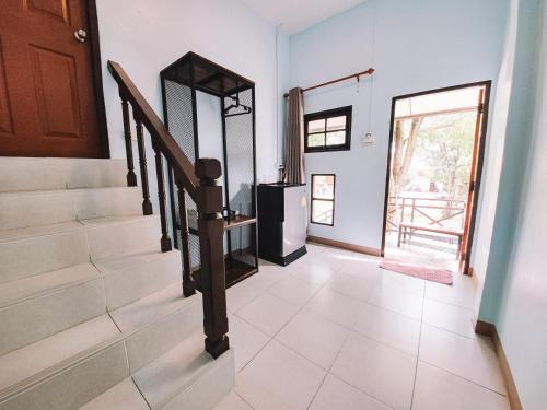 a staircase in a house with a stair case at Sophia Resort in Ban Wang Takhrai