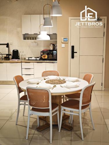 a kitchen with a white table and chairs at D' Summit Residence By JettBros Johor Bahru in Johor Bahru