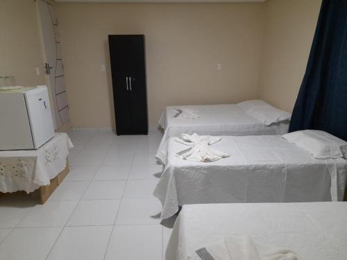 Ένα ή περισσότερα κρεβάτια σε δωμάτιο στο Castro Hospedagem