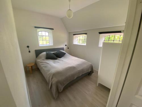 a bedroom with a bed with two pillows on it at Stutteri Skandihest Apartments in Billund