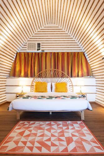 a bedroom with a large bed in a room at Nawa Wellness in Calatagan