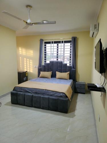 a bedroom with a large bed and a window at Jab Villa X in Adentan