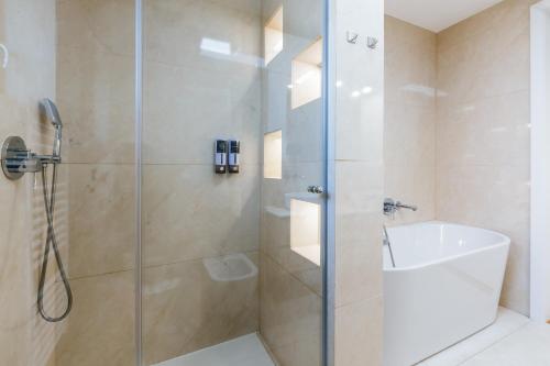 a bathroom with a shower with a glass door at HIRUNDO- villa with saunas and hot tub in Sela pri Dobovi