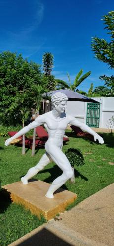 a statue of a man running on the grass at Meyers Hua Hin in Hua Hin